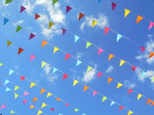 Multicolored Paper Bunting Flags In Blue Sky