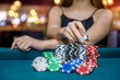 © RomanR - Female hand taking poker chips from pile
