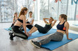 © RomanR - Group of girls are engaged in fitness under the supervision of coach