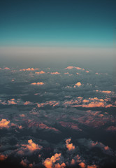 Wall Mural - Aerial sky view of clouds and mountain alpine landscape with snow tops and colorful sunset light