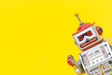 Antique Tin Toy Robot On Yellow Background. Vintage And Classic Concept Free Copy Space For Text.