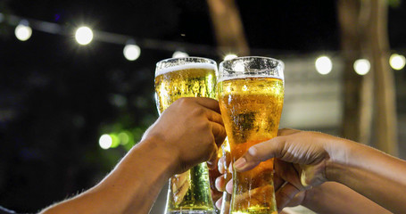 Asian group of friends having party with alcoholic beer drinks and Young people enjoying at a bar toasting cocktails and clinking glasses