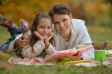 Canvas Print - Portrait of girl with her grandmother reading