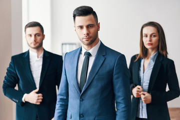 Group of successful business people with their leader in front