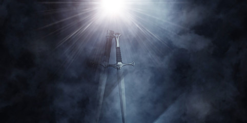 mysterious and magical photo of silver sword over gothic black background with smoke. Medieval period concept