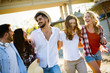 © NDABCREATIVITY - Group of young cheerful people bonding to each other and smiling