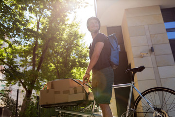 Canvas Print - Bicycle messenger making a delivery on a cargo bike