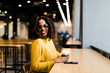 © Alexey Kuzma/Stocksy - happy young afro american woman in a fast food