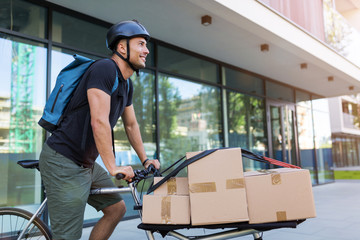 Wall Mural - Bicycle messenger making a delivery on a cargo bike