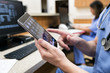 © Sean Locke Photography/Stocksy - Clinic: Male Tech Looks At CT Scans On Tablet