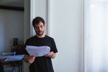 Young Man Reading Script At Home.