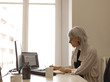 © Milles Studio/Stocksy - Stylish businesswoman at table in office