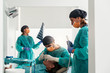 © Santi Nunez/Stocksy - Team of surgeons during a dental surgery with a patient.