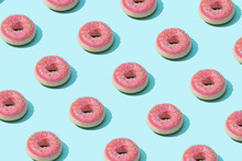 Trendy Sunlight Summer Pattern Made With Pink Doughnut On Bright Light Blue Background. Minimal Summer Concept.