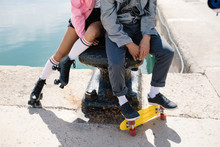 Crop Hipster Couple On Pier With Skates