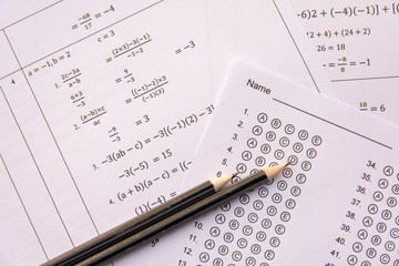 Pencil on answer sheets or Standardized test form with answers bubbled. multiple choice answer sheet .