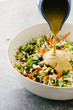 © CWP, LLC/Stocksy - Sunbutter dressing being poured over a Broccoli and Cauliflower Salad