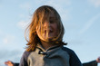 © Rob and Julia Campbell/Stocksy - Smiling kid with long hair in his eyes