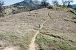 © L?a Jones/Stocksy - little girl with blue dress running on a mountain