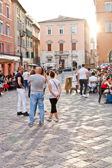 Wall Mural - Ancona, Italy - June 8 2019: People enjoying summer day and food at outdoor restaurant and resting.