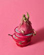 © Yaroslav Danylchenko/Stocksy - A dragon fruit or Pitaya cut into slices made up on a pink backg