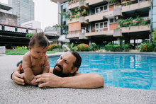Father And Baby Poolside