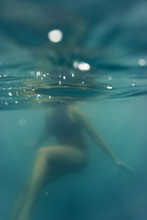 Unrecognisable Female Body Swimming. Selective Focus Abstract