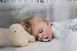 © Kelly Knox/Stocksy - toddler napping in his crib