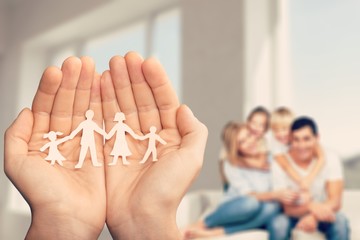 Poster - Love and relationships concept - closeup of man's cupped hands showing paper  family