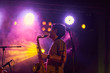 © Miquel Llonch/Stocksy - Young musician playing saxophone in a live concert