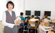 © JackF - Friendly female teacher in computer class