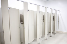 Several Toilet Stalls In A Public Restroom