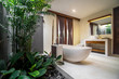 © Bisual Studio/Stocksy - Luxury bathroom with bathtub in a villa, Ubud