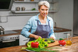 © Pixel-Shot - Mature woman cooking in kitchen