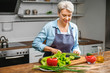 © Pixel-Shot - Mature woman cooking in kitchen