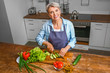 © Pixel-Shot - Mature woman cooking in kitchen