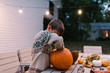 © L?a Jones/Stocksy - boy carving a big pumpkin