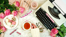 Romantic Vintage Feminine Writing Scene, Tea Break With Old Typewriter And Pink Roses On Marble Table Top Down Overhead.