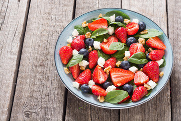 Wall Mural - Summer Strawberry salad with spinach , cheese , nuts and blueberry