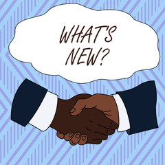 Conceptual hand writing showing What S New Question. Concept meaning Asking about latest Updates Trends Happening News Hand Shake Multiracial Male Colleagues Formal Shirt Suit