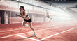 © Sergey Nivens - Woman sprinter in action on stadium