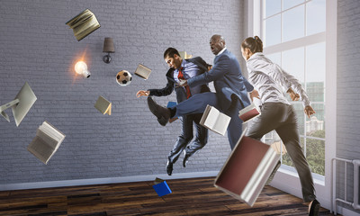 Wall Mural - Black businessman in a suit playing footbal