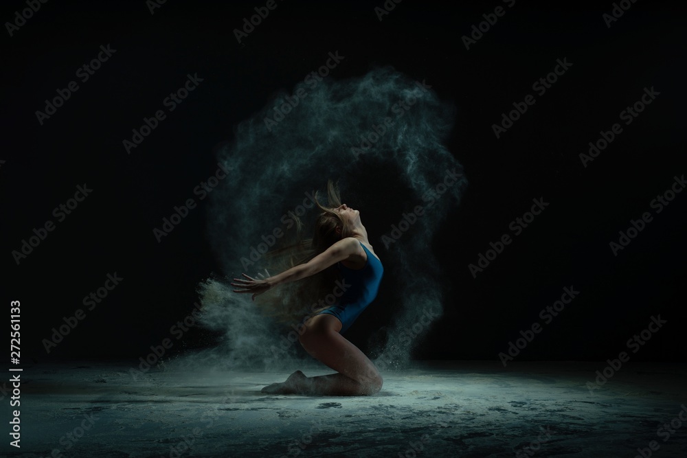 Graceful barefoot woman dancing in cloud of dust - obrazy, fototapety, plakaty 