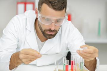 smart scientist man with glasses test liquid