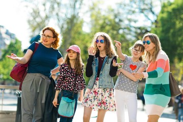 Group of girls walking through downtown - pointing