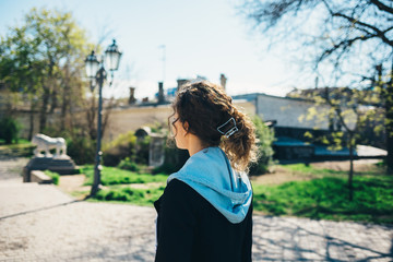 Rear view of young woman with curly hair