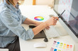 © Anton - graphic web designer does the work using a graphics tablet, desktop