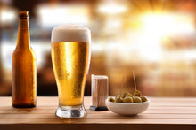 Appetizer With Glass Beer On Wooden Slatted Table In Pub
