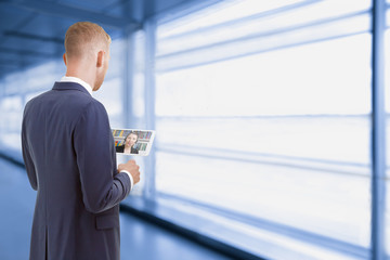 man with tablet computer talking to a colleague working in home office, telecommuting concept.