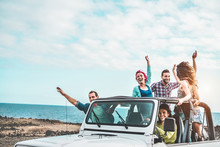 Group Of Happy Friends Doing Excursion On Desert In Convertible 4x4 Car - Young People Having Fun Traveling Together - Friendship, Tour, Youth Lifestyle And Vacation Concept - Focus On Right Guys